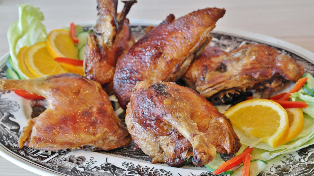 Elegant Roasted Chicken Platter with Orange, Peppers & Lettuce Wallpaper