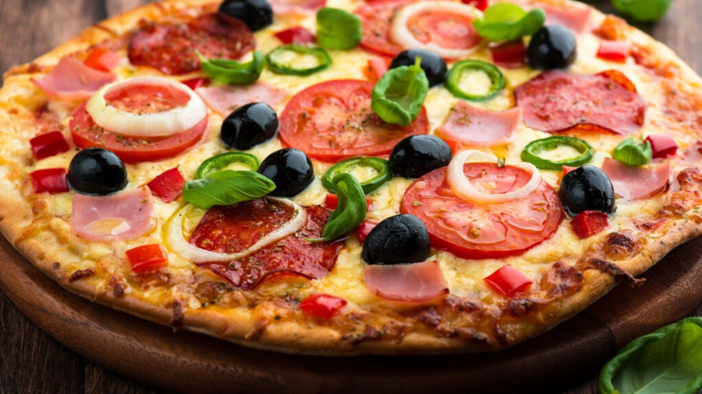 Delicious Rustic Pizza with Olives, Tomatoes, Pepperoni & Basil Wallpaper