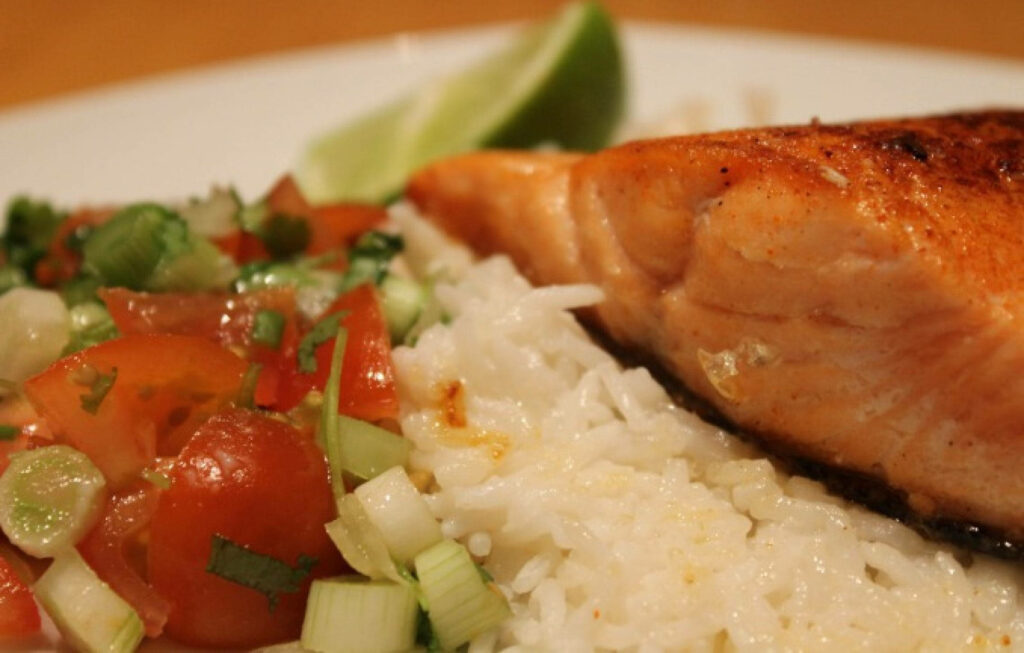 Delicious Salmon Fillet Wallpaper with Rice, Tomatoes & Lime Garnish
