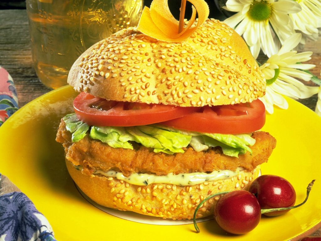 Delicious Sesame Bun Sandwich with Crispy Meat & Fresh Veggies Wallpaper