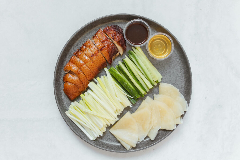 Beautifully Arranged Sliced Peking Duck with Cucumbers & Pancakes Wallpaper