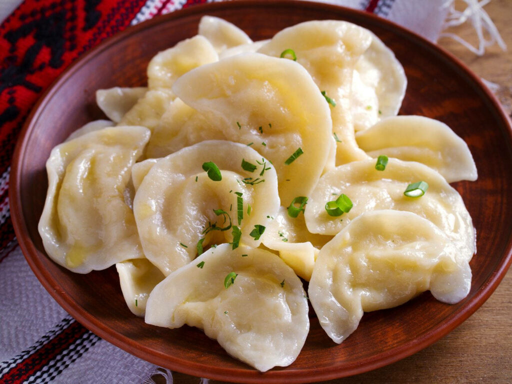 Rustic Soft Pierogi Dumplings with Green Onions - Appetizing Wallpaper