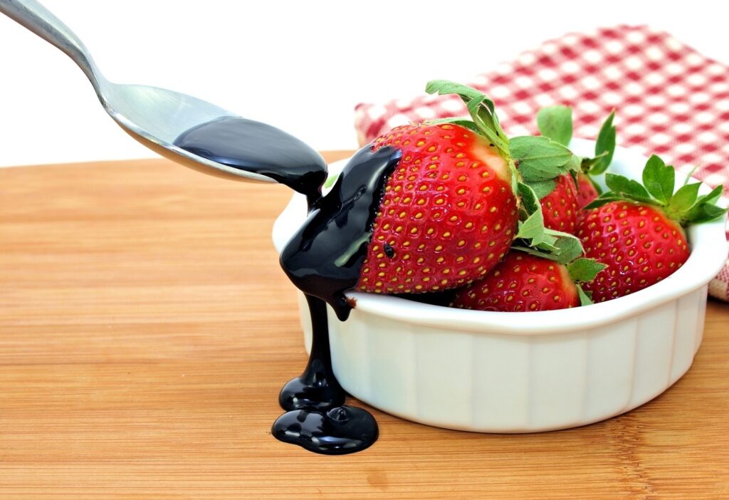 Delicious Strawberry Wallpaper with Chocolate Drizzle on Wood Background