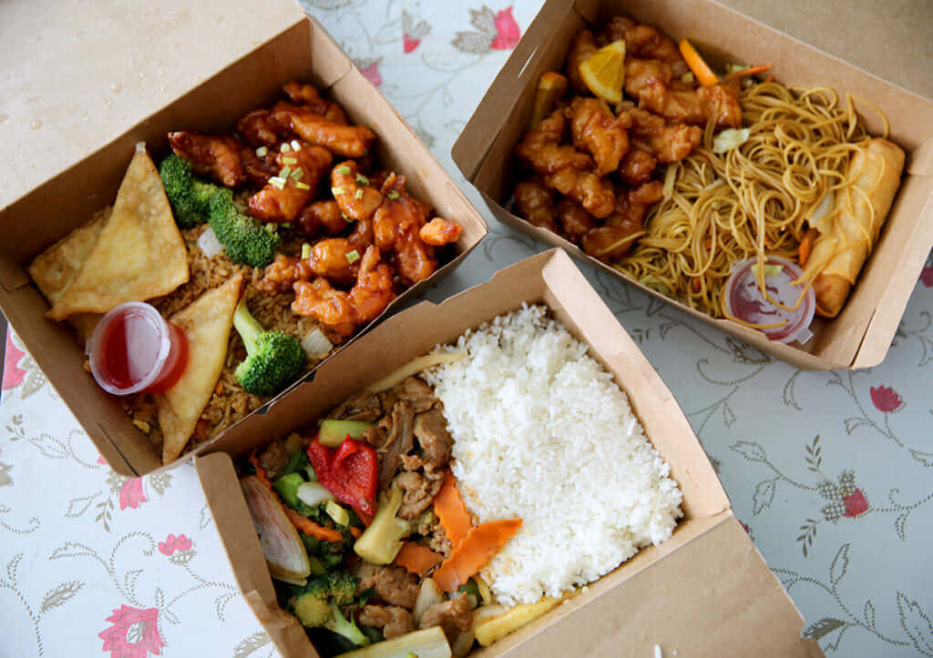 Colorful Takeout Feast: Fried Rice, Orange Chicken & Spring Rolls Wallpaper