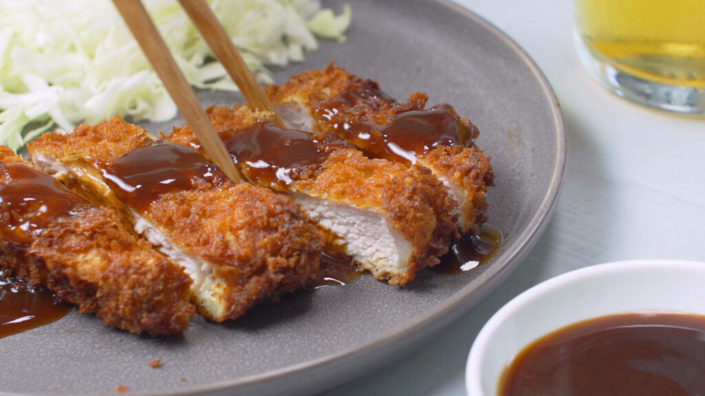 Delicious Tonkatsu Cutlet with Savory Sauce & Shredded Cabbage Wallpaper