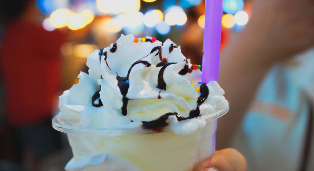 Delicious Vanilla Milkshake Wallpaper with Whipped Cream & Sprinkles