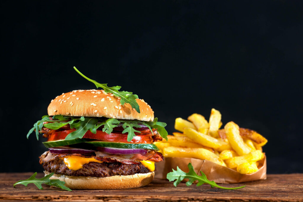 Delicious Veggie Cheeseburger & Fries on Rustic Wooden Wallpaper