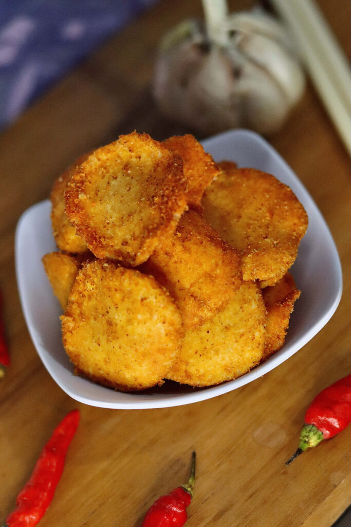 Delicious Chicken Nuggets Wallpaper with Chili Peppers & Rustic Wood
