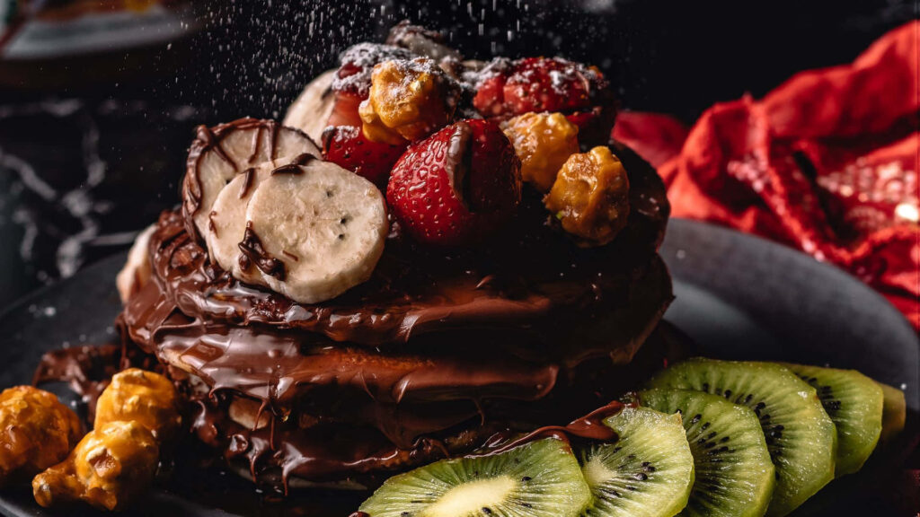 Tempting Chocolate Pancake Delight with Fresh Fruity Accents Wallpaper