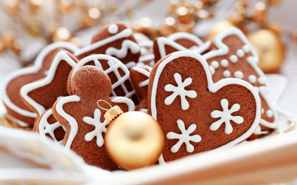 Festive Christmas Cookies Adorned with Creamy White Icing Wallpaper