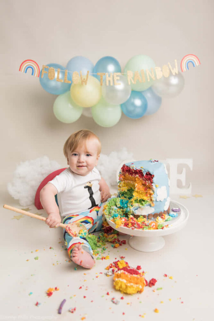 Joyful Baby Birthday Cake Smash Wallpaper with Rainbow Decor