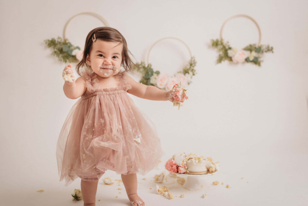 Whimsical Baby Cake Smash Wallpaper with Floral Decor Delight