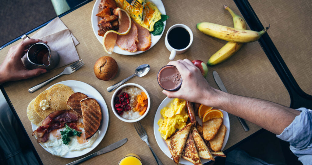 Inviting Breakfast Spread: Pancakes, Eggs, Toast & Fruits Wallpaper