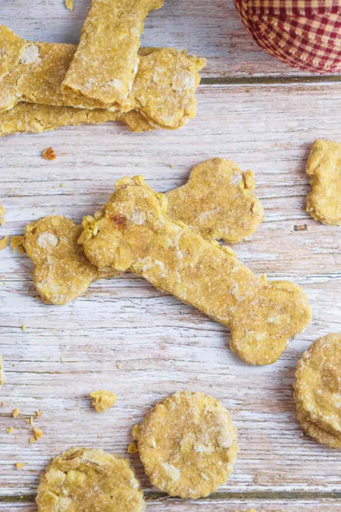 Doggie Delights: Tempting Bone-shaped Treats on a Rustic Wooden Canvas Wallpaper