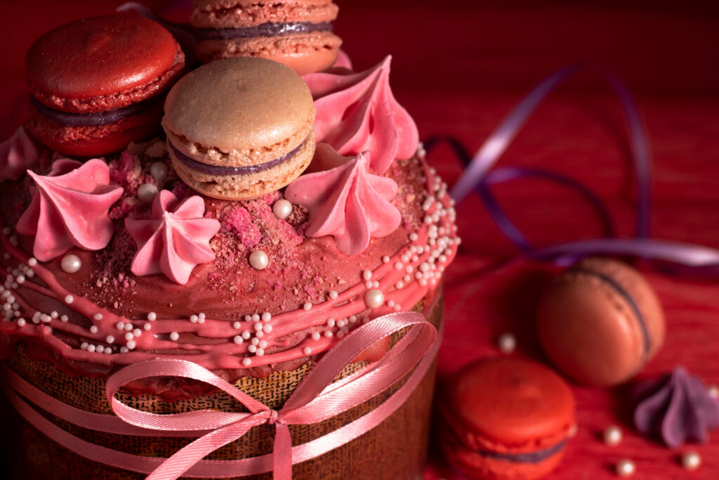 Festive Chocolate Cake Wallpaper with Colorful Macarons & Frosting