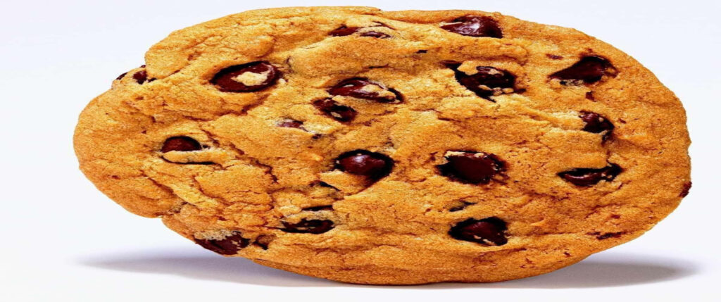 Delectable Chocolate Chip Cookies: Scrumptious Treats on a Serene White Canvas Wallpaper