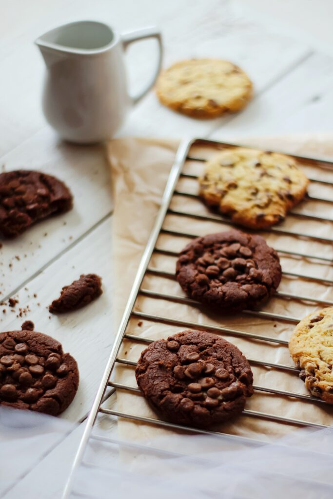 Charming Chocolate Chip Cookies on a Rustic Cooling Grill Background Wallpaper