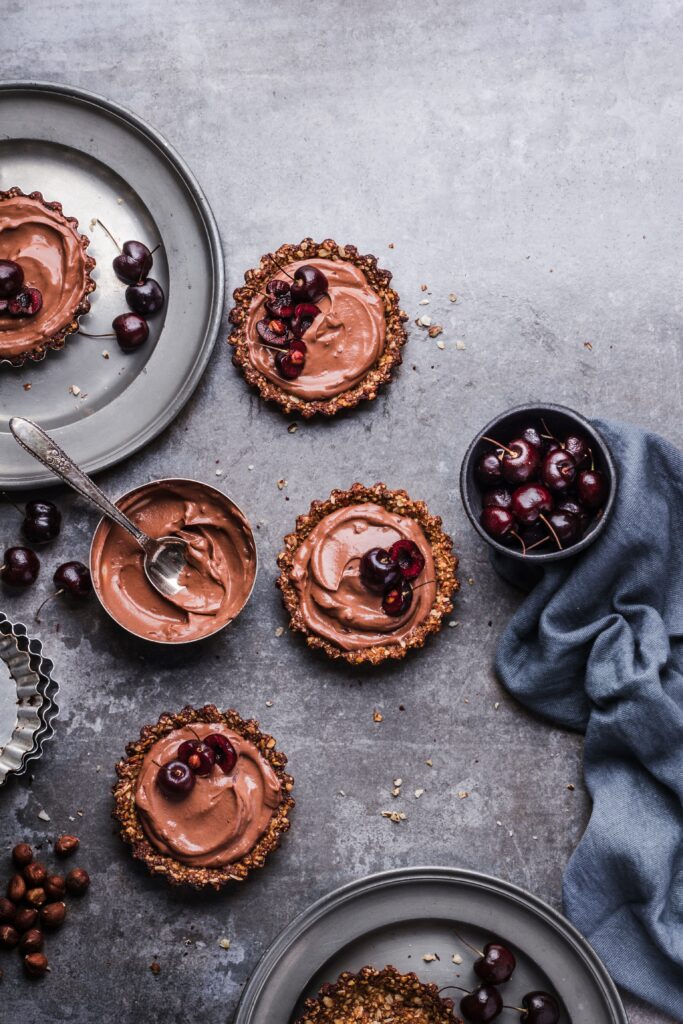 Delicious Chocolate Pastry Wallpaper with Fresh Berries & Rustic Plates