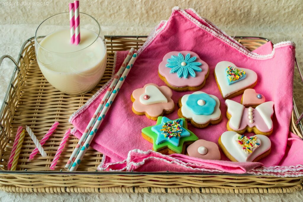 Charming Cookie Wallpaper: Decorated Treats with Milk on Pink Napkin