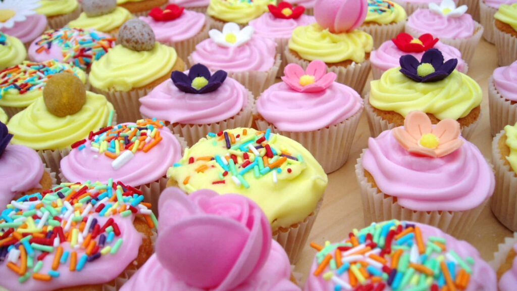 Colorful Cupcake Wallpaper: Cheerful Floral Treat for Your Background
