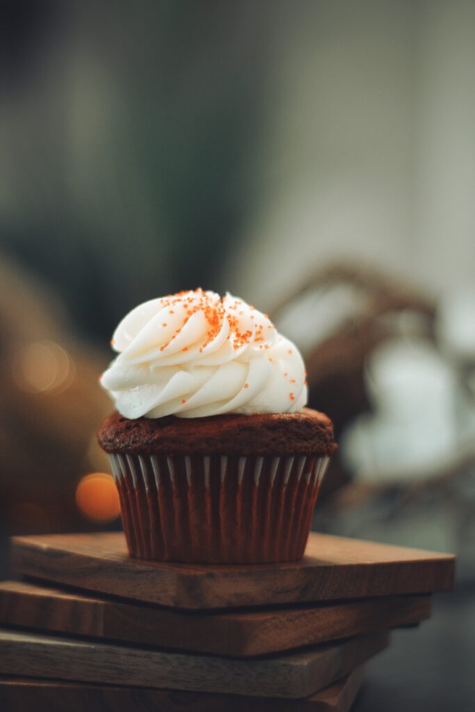 Delightful Cupcake with Creamy Frosting & Orange Sprinkles - Wallpaper