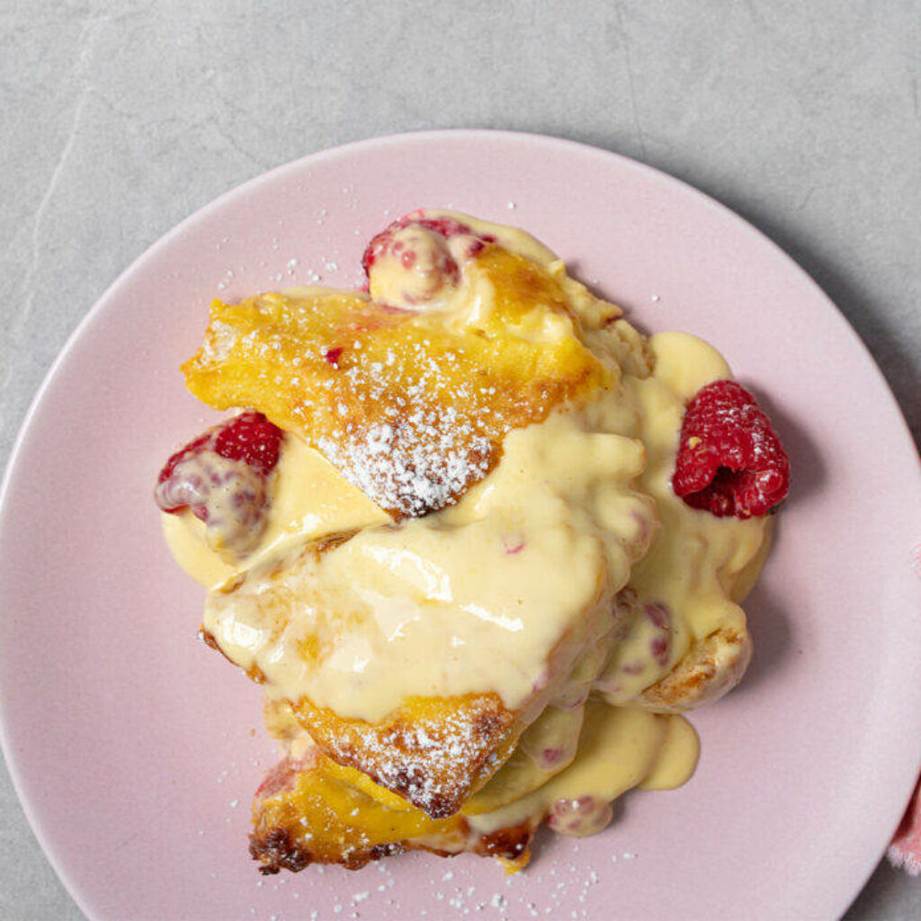 Delicious Pink Plate Dessert with Raspberries & Butter Topping Wallpaper