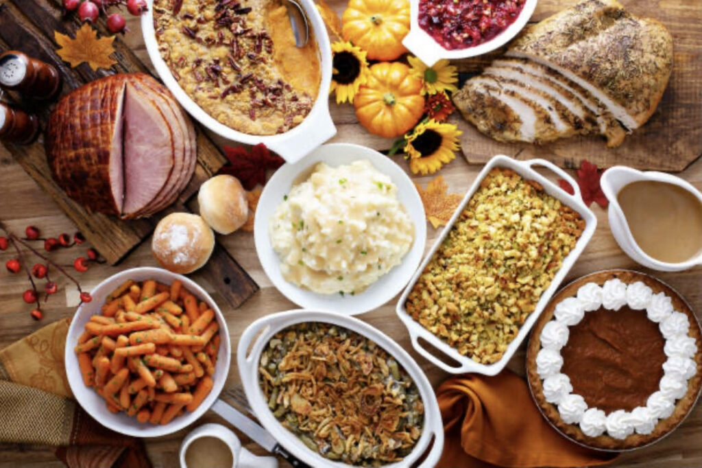 Festive Holiday Dinner Spread: Roasted Turkey & Seasonal Sides Wallpaper