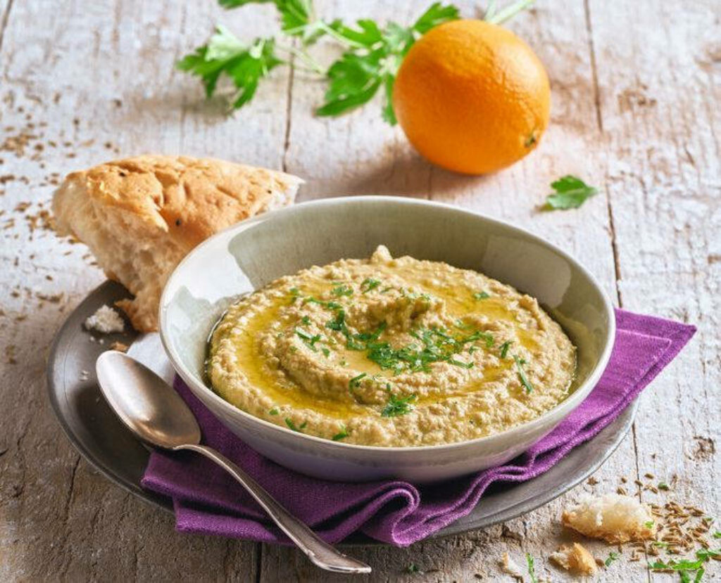 Delightful Hummus Wallpaper with Fresh Bread & Orange on Rustic Surface