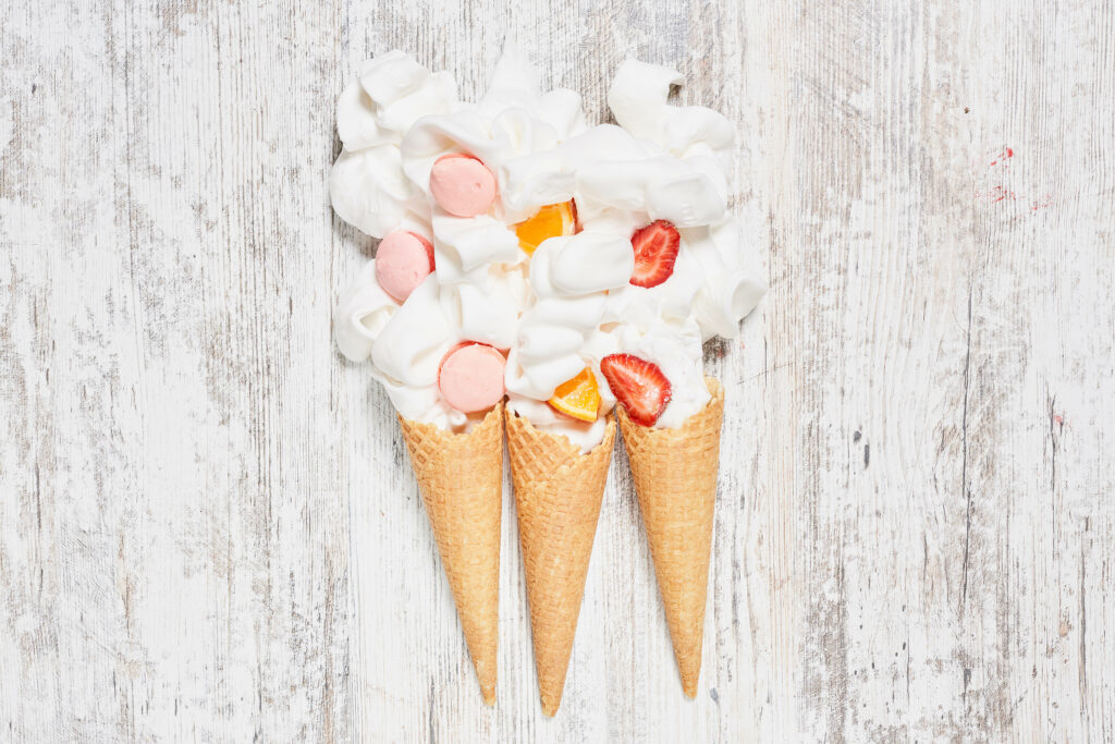Delightful Ice Cream Cone Wallpaper with Whipped Cream & Fruits