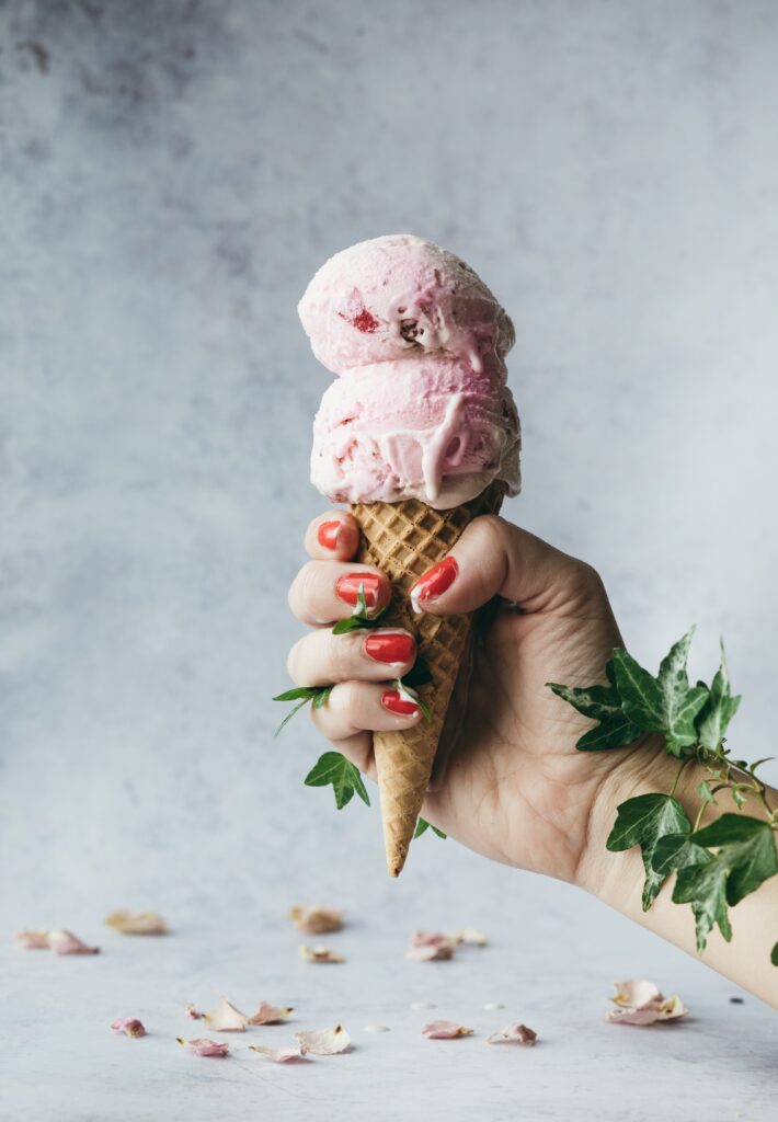 Charming Ice Cream Cone Wallpaper with Vines and Pastel Background