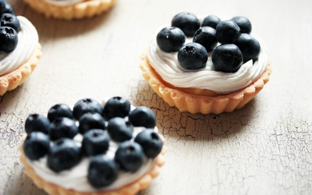 Miniature Tartlets with Creamy Swirls & Blueberries Wallpaper Background