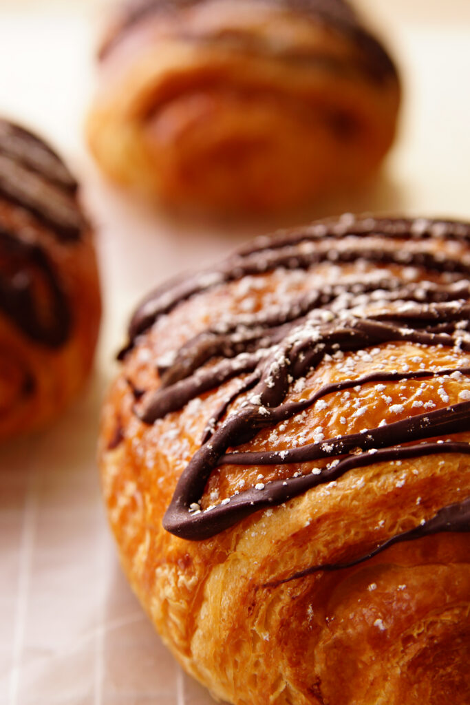Delicious Pastries with Chocolate Drizzle - Wallpaper Background