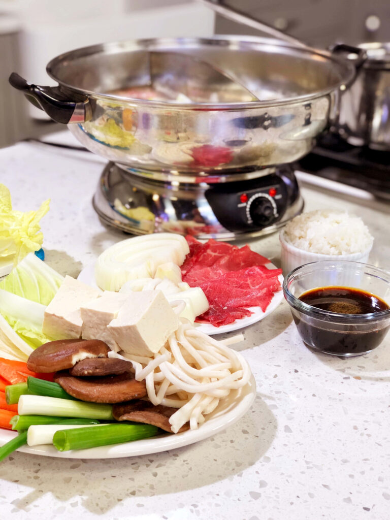 Delicious Shabu-Shabu Setup with Fresh Ingredients & Dipping Sauce Wallpaper