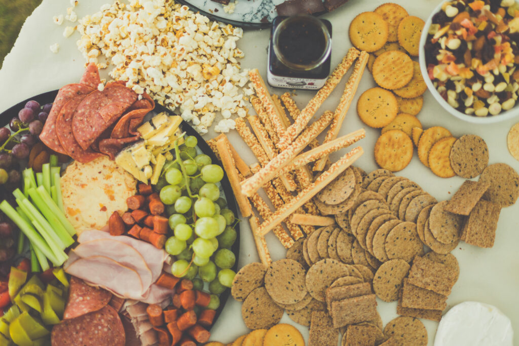 Vibrant Snack Spread: Fruits, Cheese, Crackers & More Wallpaper