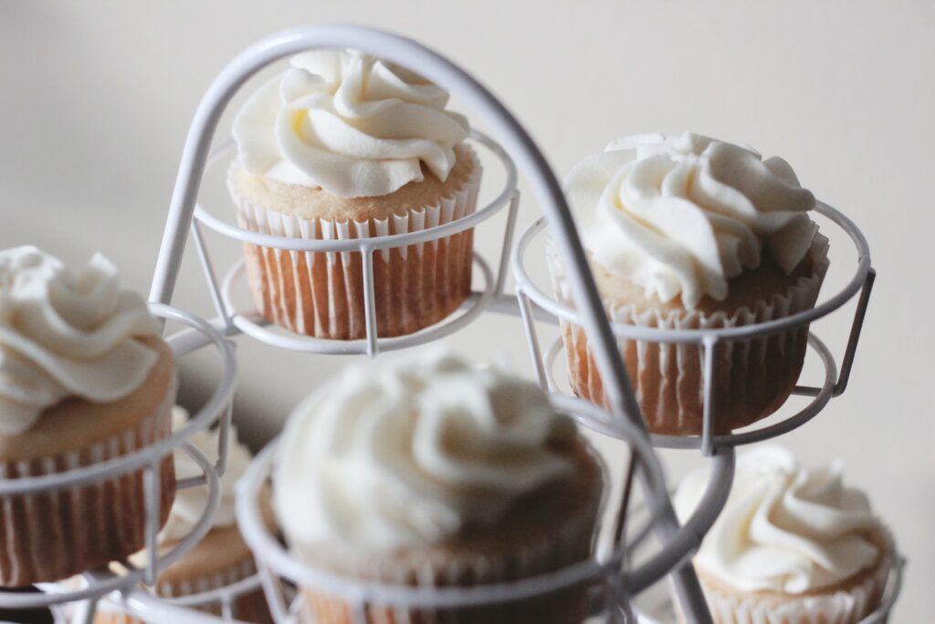 Delightful Vanilla Cupcake Wallpaper with Cream Icing Background
