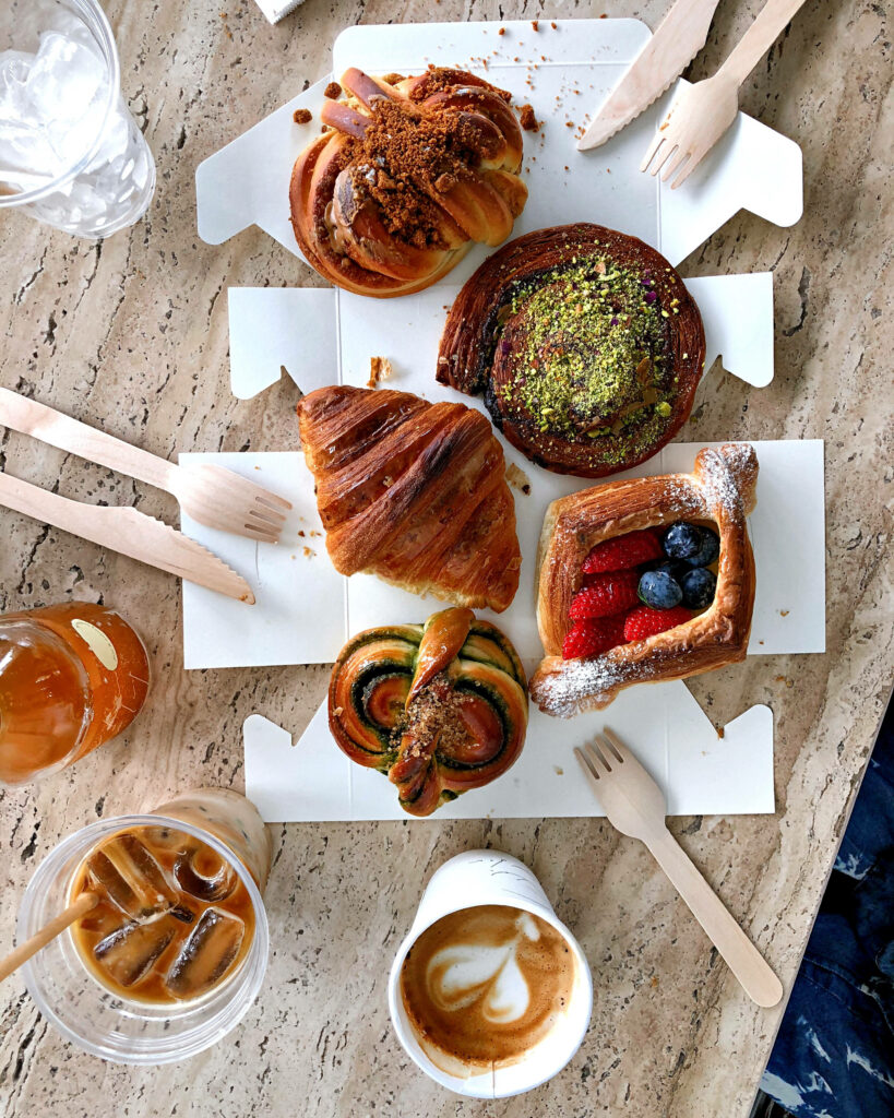 Cozy iPhone Wallpaper: Fresh Pastries & Coffee on Rustic Table
