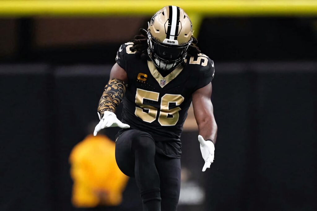 Demario Davis intense action linebacker in black gold New Orleans Saints uniform at vibrant stadium Wallpaper