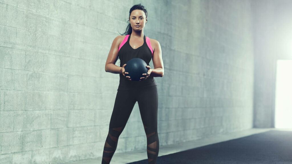 Demi Lovato: Strength & Determination in Fitness Attire Wallpaper