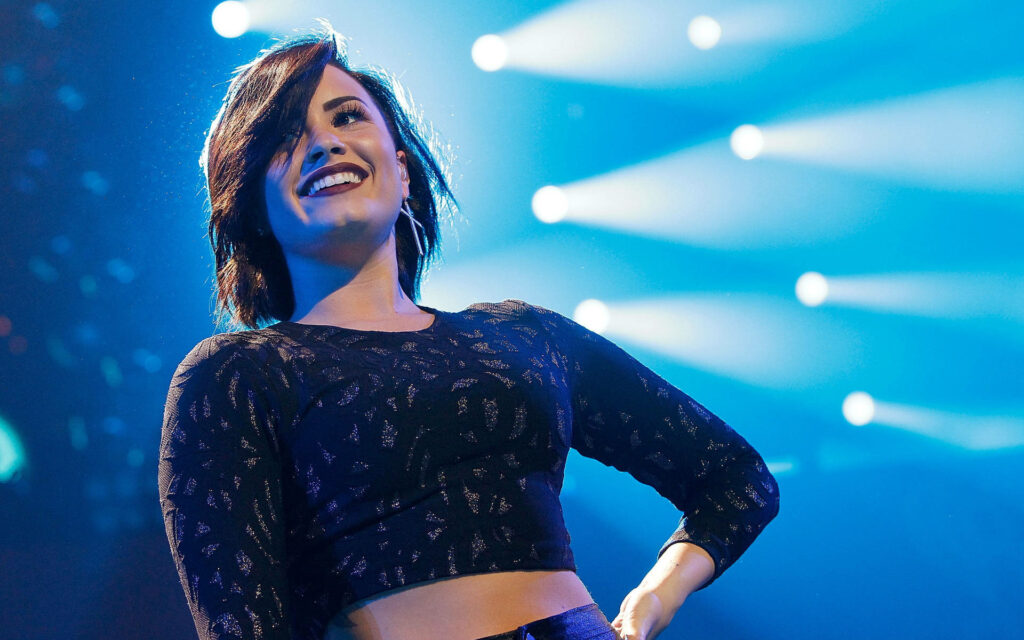 Demi Lovato Live: Dynamic Stage Performance Wallpaper Background