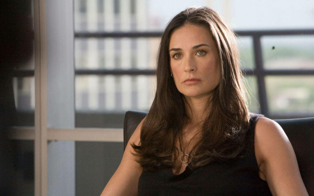 Demi Moore serious indoors natural light large window modern muted wallpaper calm elegant pose