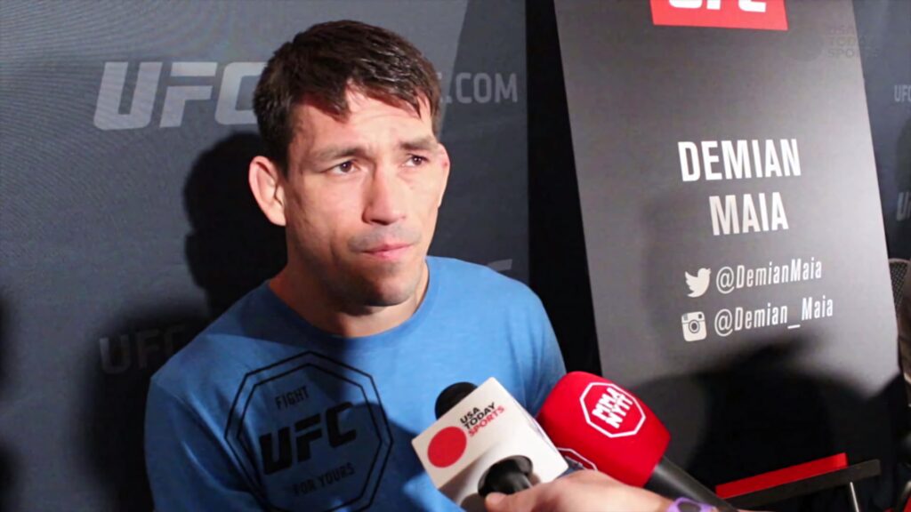Demian Maia UFC fighter post-fight interview in blue shirt with UFC backdrop and microphones Wallpaper