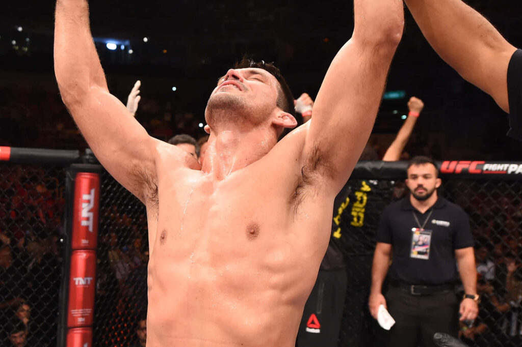 Demian Maia UFC victory celebration in octagon with arms raised triumphant in packed arena Wallpaper