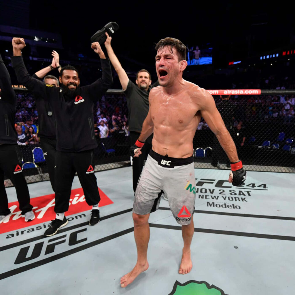 Demian Maia victorious UFC fighter celebrating with intense expression and sweaty body in octagon Wallpaper