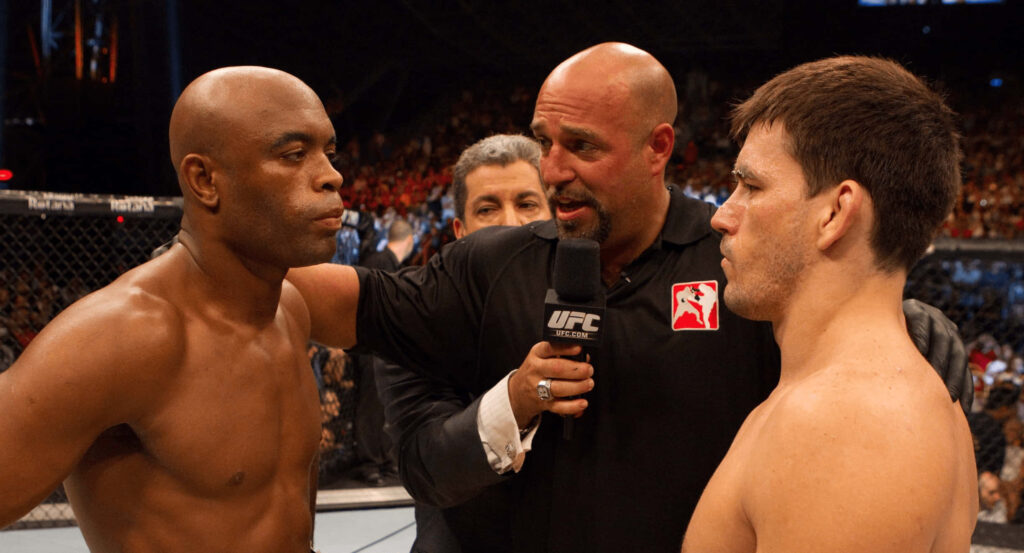 Demian Maia and Anderson Silva UFC faceoff intense octagon fight dramatic lighting packed arena Wallpaper