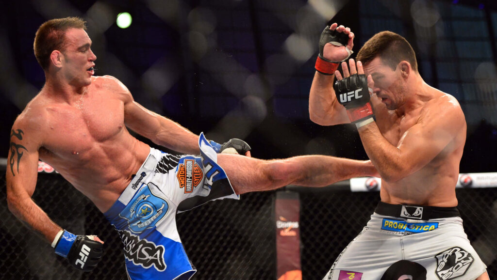 Demian Maia and Jake Shields in intense UFC fight action inside the octagon with powerful kick Wallpaper