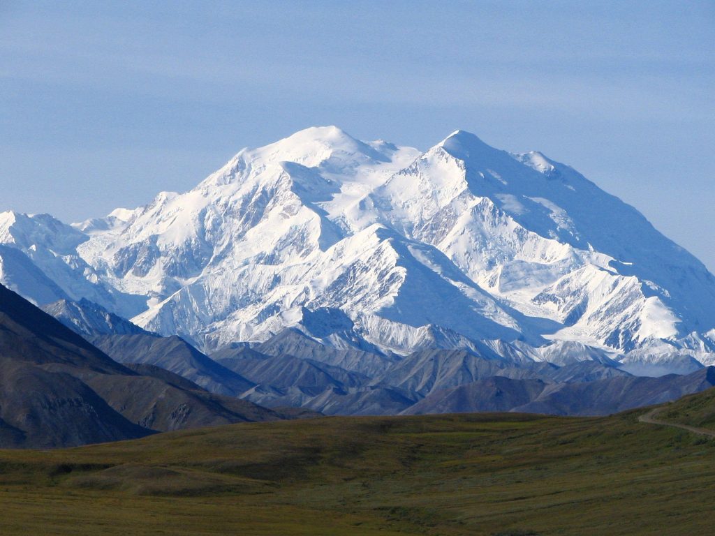 Denali mountain landscape with snow-covered peaks rugged foothills and expansive tundra background Wallpaper