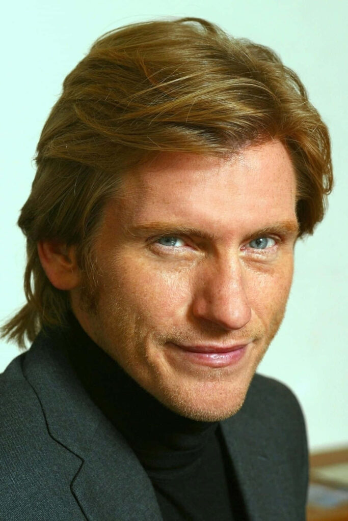 Denis Leary portrait wallpaper with sharp features piercing blue eyes and blond hair background