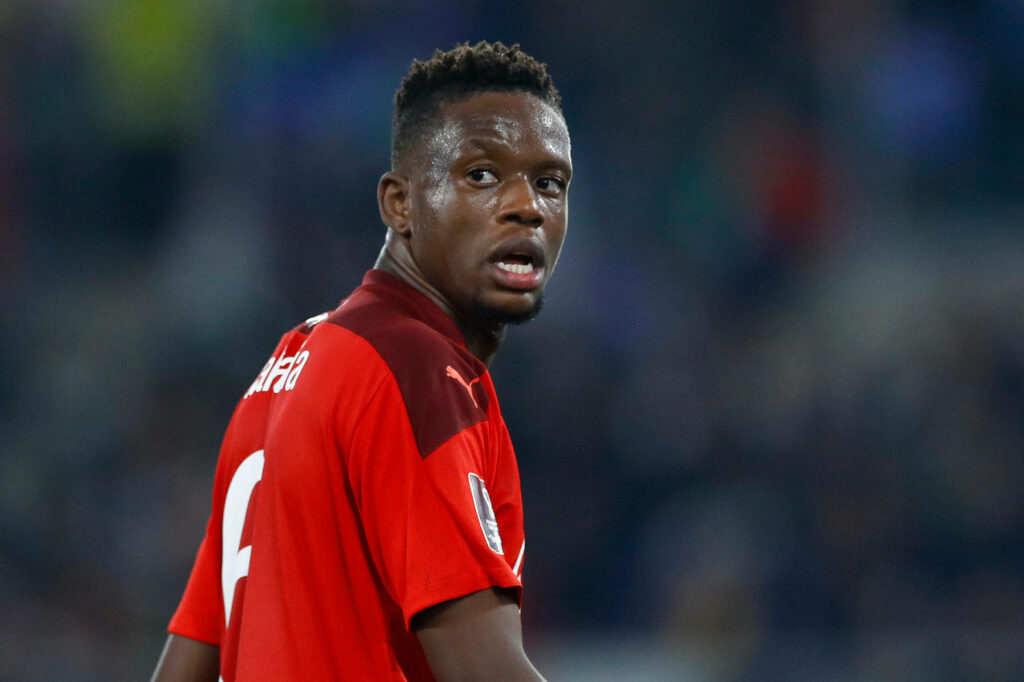 Denis Zakaria in red jersey mid-action with intense focus blurred stadium background sports wallpaper