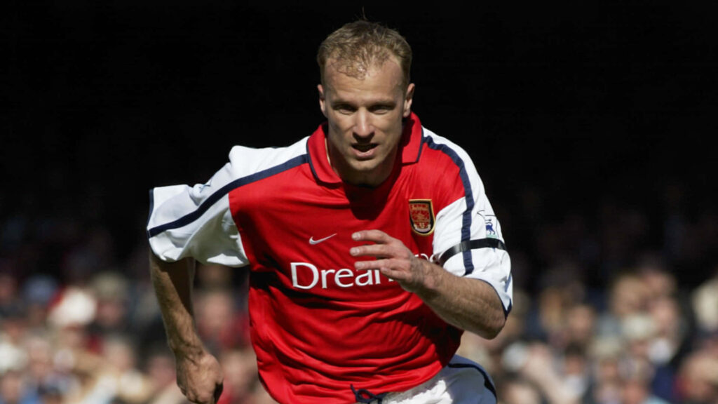 Dennis Bergkamp in red and white Arsenal kit focused during match versus Blackburn Rovers wallpaper
