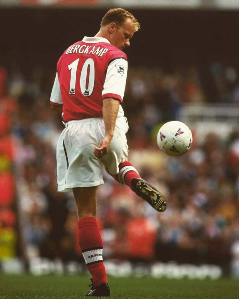 Dennis Bergkamp in Arsenal number 10 kit controlling ball against Bradford City on football pitch Wallpaper